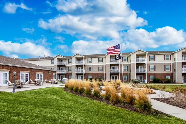 Connect55+ La Vista community building exterior with patio