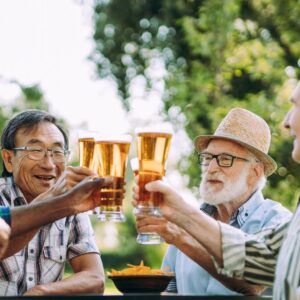 Senior guys toasting drinks