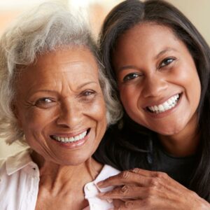 mom and daughter smiling