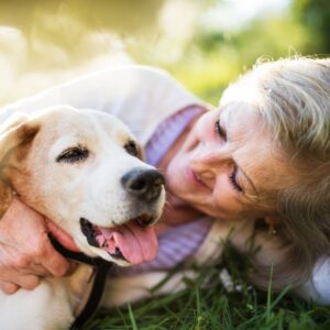 woman cuddling dog