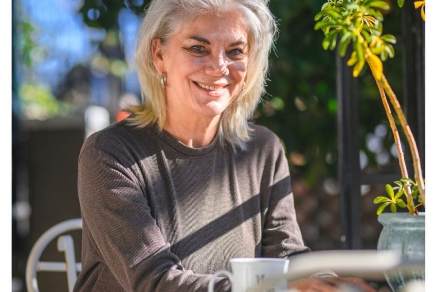 A smiling senior lady on her with question on 55+ communities