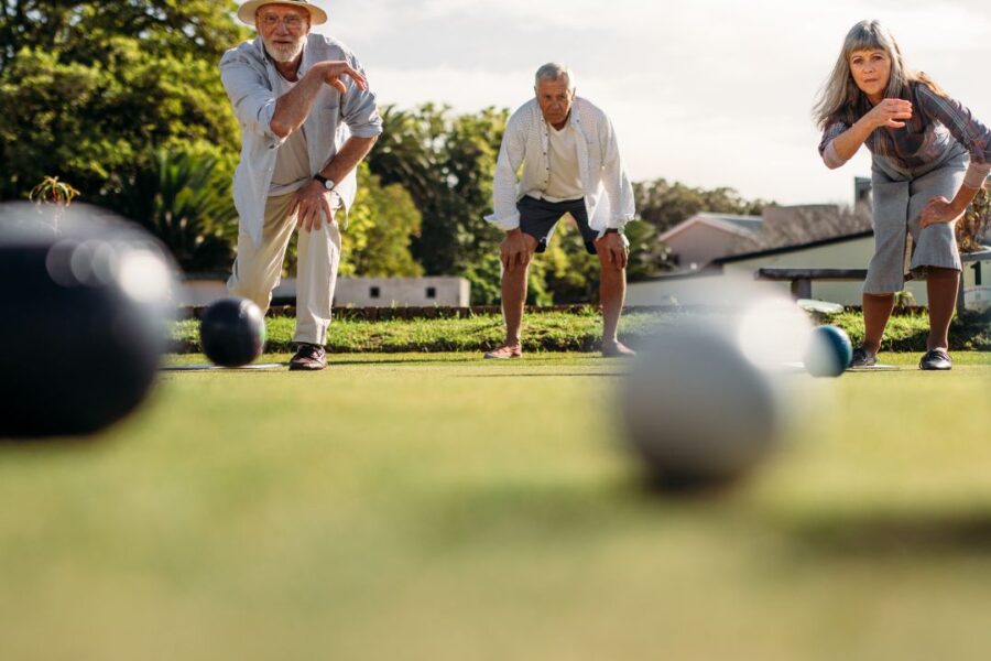 seniors playing outdoor games in a 55+ active senior living community