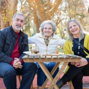 elderly friends sitting at an outdoor table