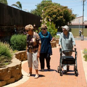 elderly women at a flower garden