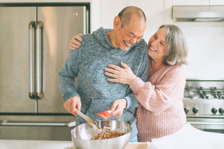 a senior couple cooking in the kitchen