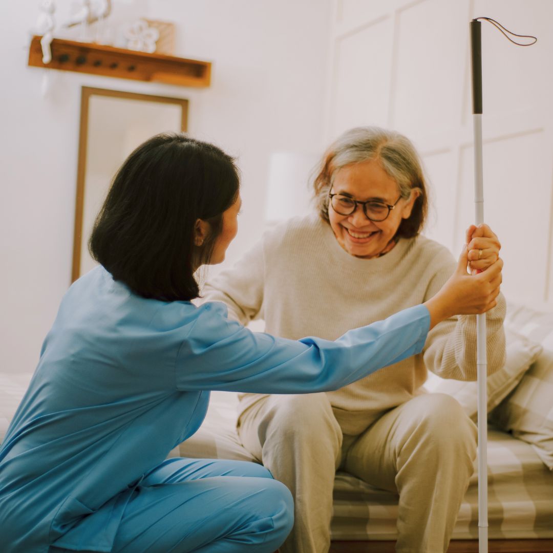 a nurse helping a senior resident of an assisted living facility out of bed