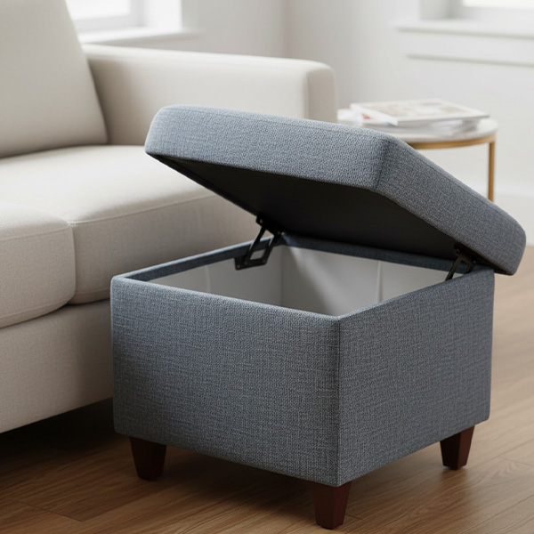 A stylish, upholstered storage ottoman is shown open, revealing a tidy interior space.