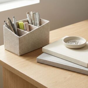 Close-up view of neat office supplies and notebooks placed on a clean desk surface.